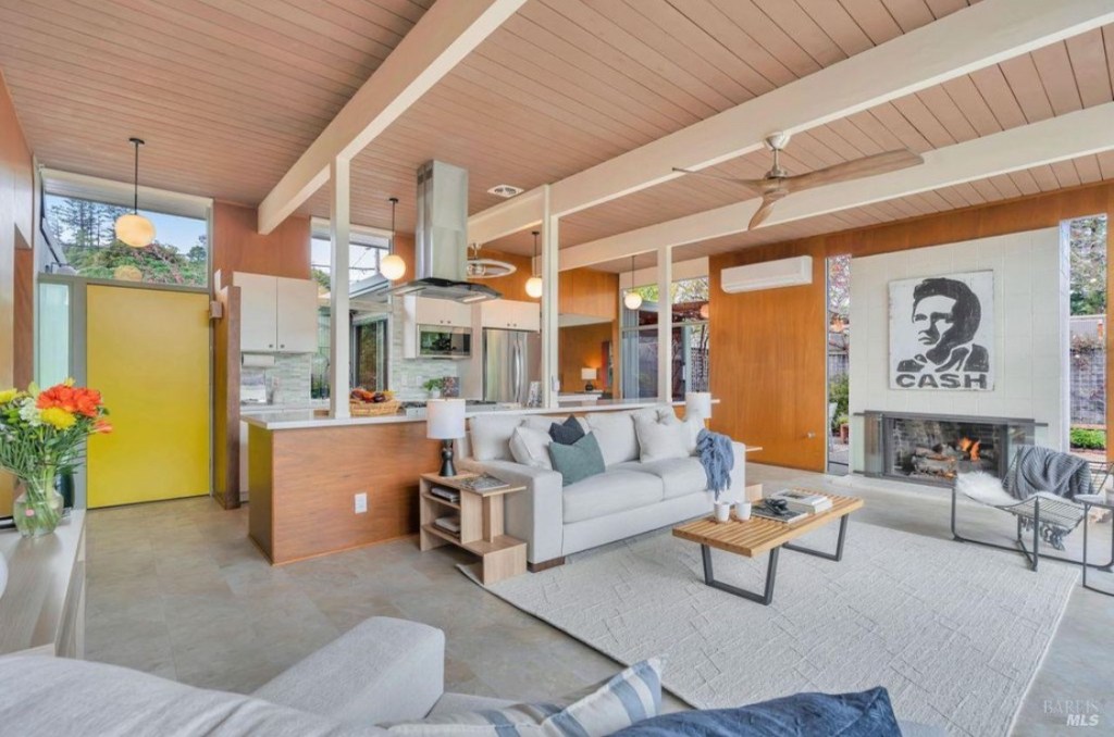 Mid-Century Modern Eichler home staged with contemporary modern furniture and design elements, showcasing spacious living room with clean lines, stylish decor, and natural light.